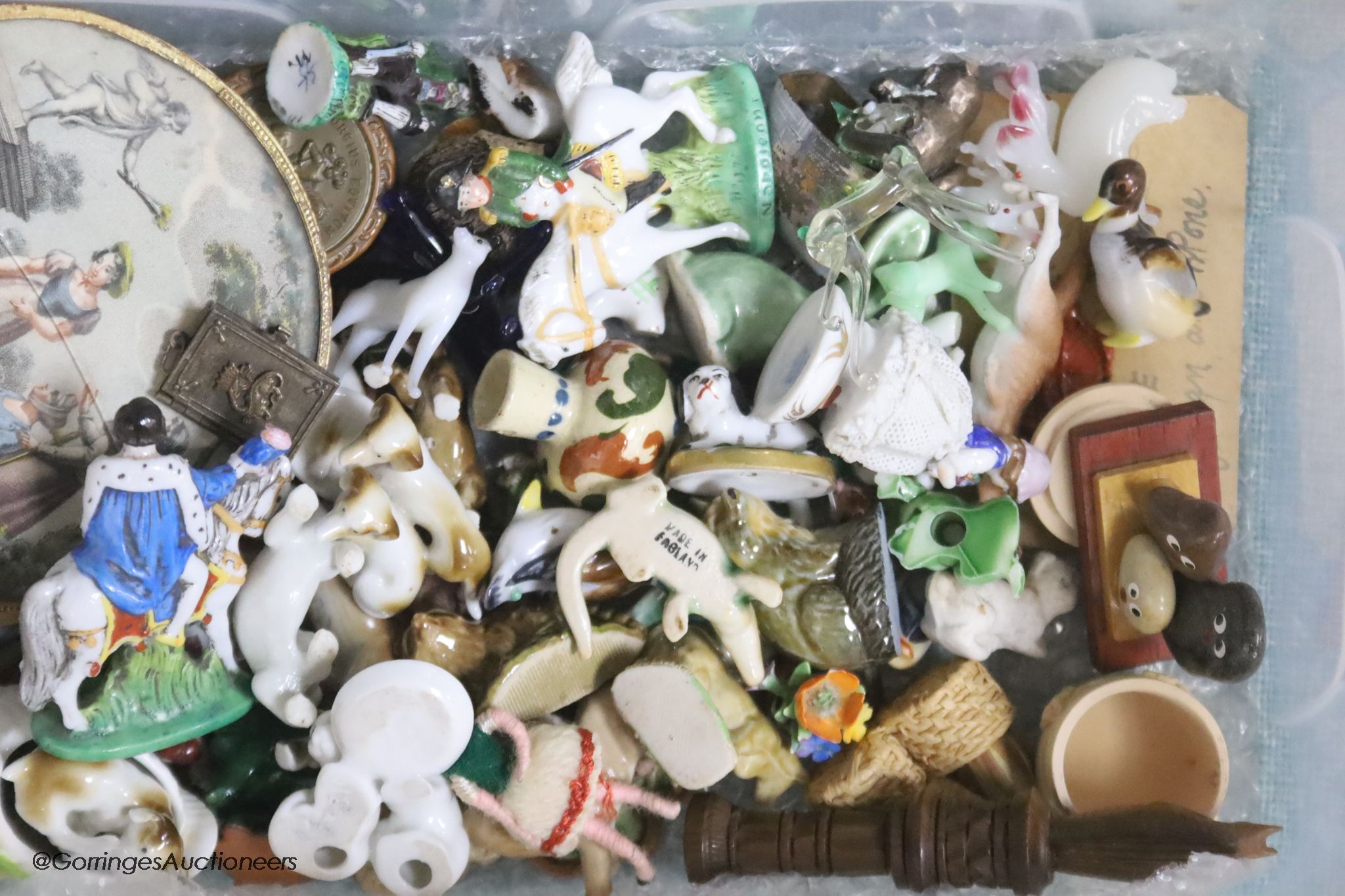 A collection of miniature ceramic and glass figures and animals, treen, enamel patch boxes, souvenirs and curios